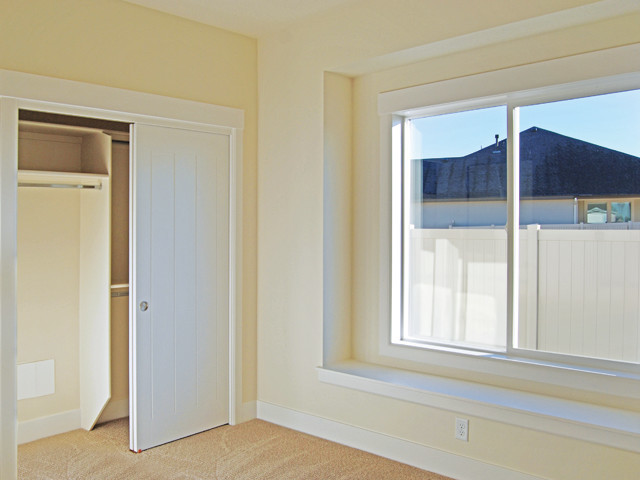 Photo of a small transitional guest bedroom in Boise with white walls, carpet and no fireplace.