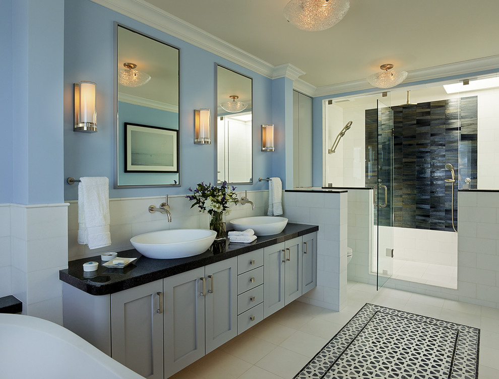 Design ideas for a transitional bathroom in San Francisco with a vessel sink, blue cabinets, an alcove shower, white tile and blue walls.