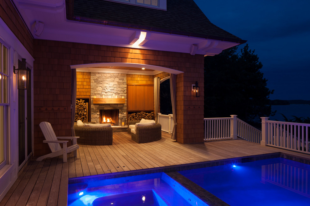 This is an example of a large traditional backyard rectangular pool in Other with decking.