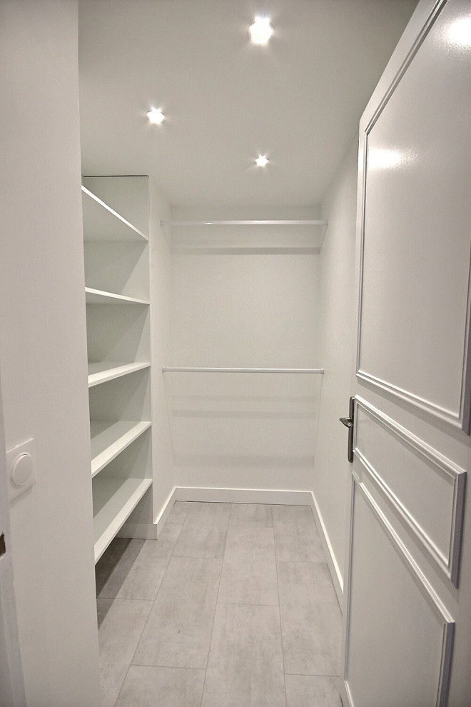 Design ideas for a medium sized modern gender neutral dressing room in Other with open cabinets, white cabinets, vinyl flooring and grey floors.