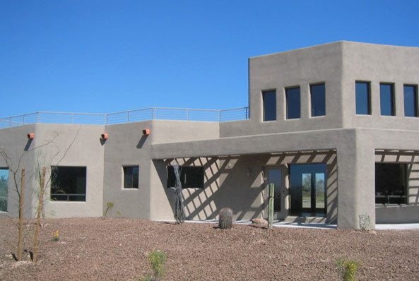 Photo of a modern two-storey adobe beige exterior in St Louis with a flat roof.