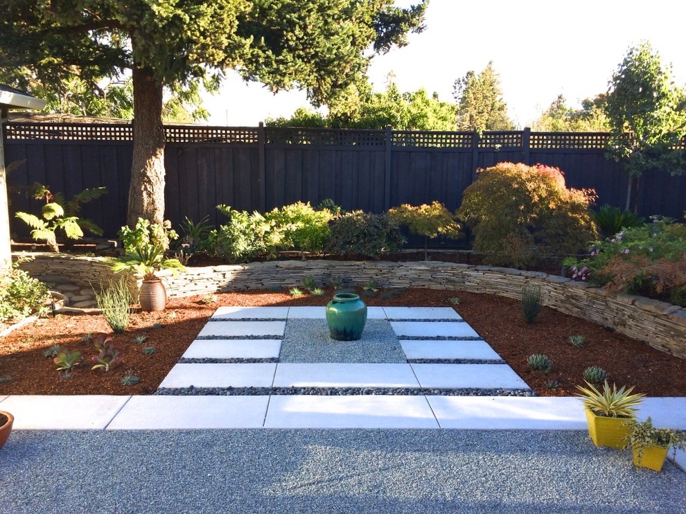 Photo of a mid-sized asian backyard full sun xeriscape in San Francisco with a retaining wall and concrete pavers.