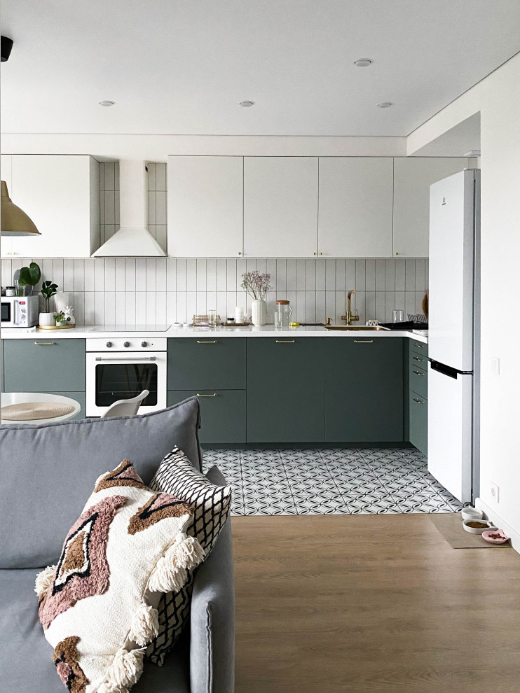 Inspiration for a mid-sized scandinavian l-shaped open plan kitchen in Moscow with an undermount sink, flat-panel cabinets, solid surface benchtops, white splashback, ceramic splashback, porcelain floors, no island, white floor and white benchtop.