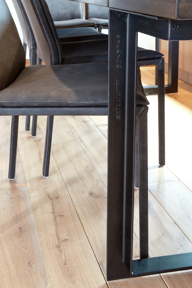 Inspiration for a small transitional medium tone wood floor dining room remodel with white walls