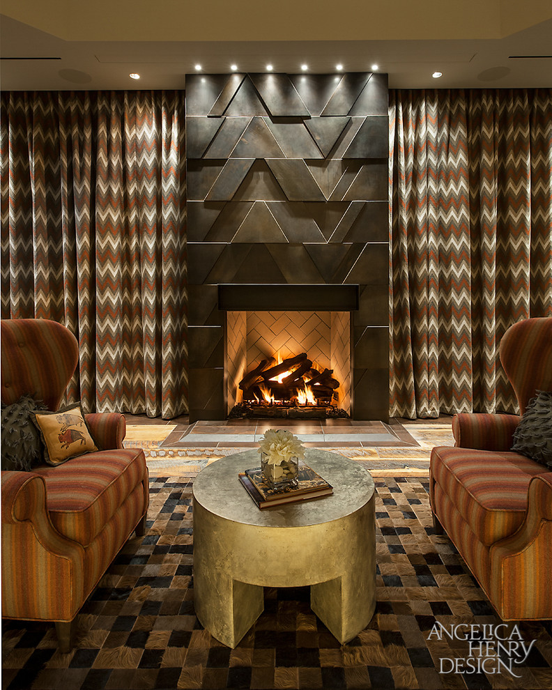 Inspiration for a rustic master medium tone wood floor bedroom remodel in Phoenix with beige walls, a standard fireplace and a metal fireplace