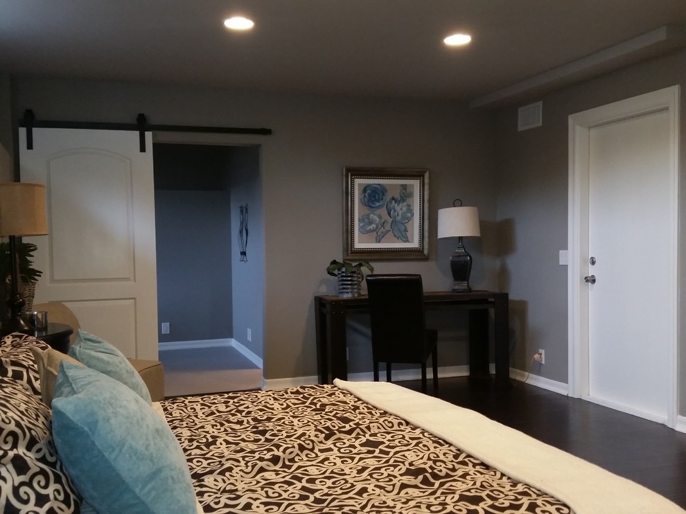 This is an example of a large traditional guest bedroom in Los Angeles with grey walls and dark hardwood floors.