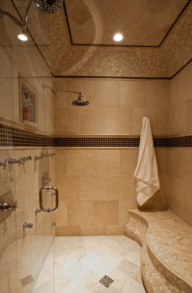 Large traditional master bathroom in Chicago with an undermount sink, raised-panel cabinets, medium wood cabinets, limestone benchtops, a drop-in tub, an alcove shower, a two-piece toilet, beige tile, stone tile, yellow walls and limestone floors.
