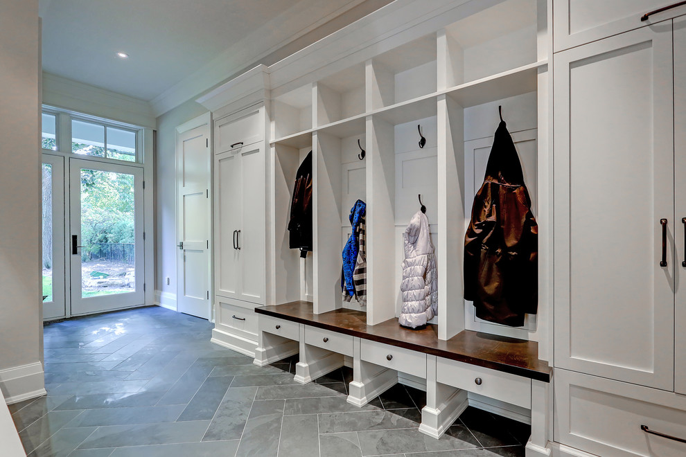 Mudroom - mid-sized transitional porcelain tile and gray floor mudroom idea in Toronto with gray walls and a glass front door