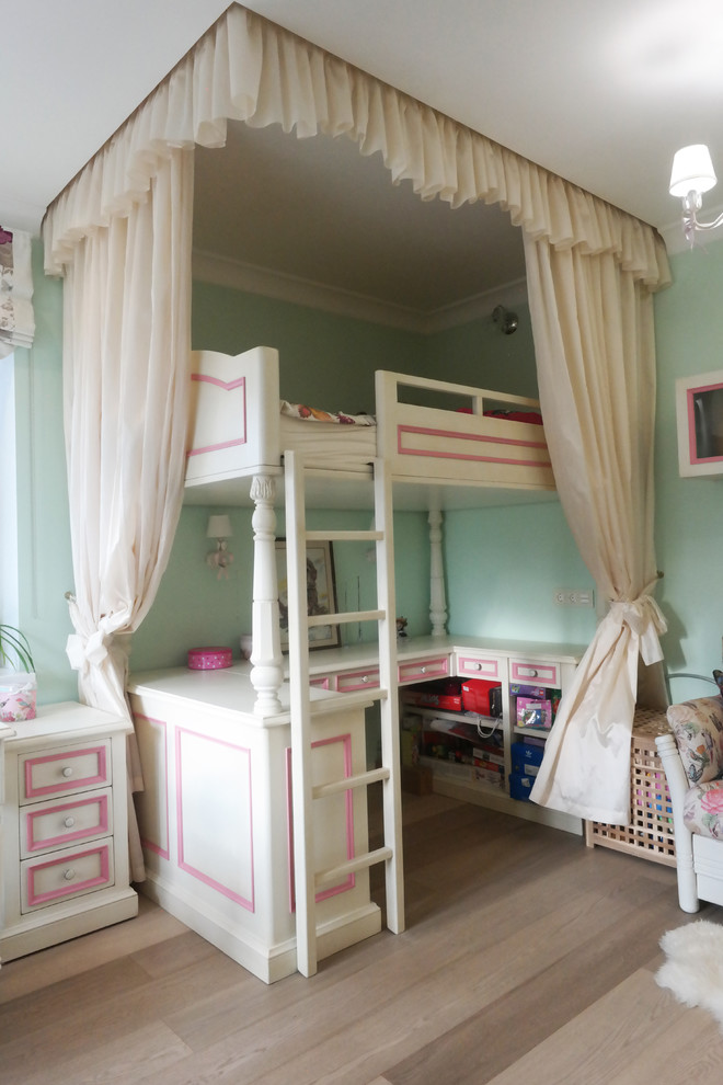 Design ideas for a mid-sized traditional kids' room for girls in Moscow with green walls and medium hardwood floors.