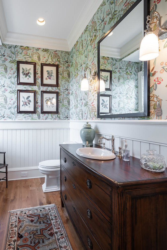 Design ideas for a traditional bathroom in Charleston with dark wood cabinets, white walls, medium hardwood floors, a drop-in sink, wood benchtops, brown floor, brown benchtops and flat-panel cabinets.