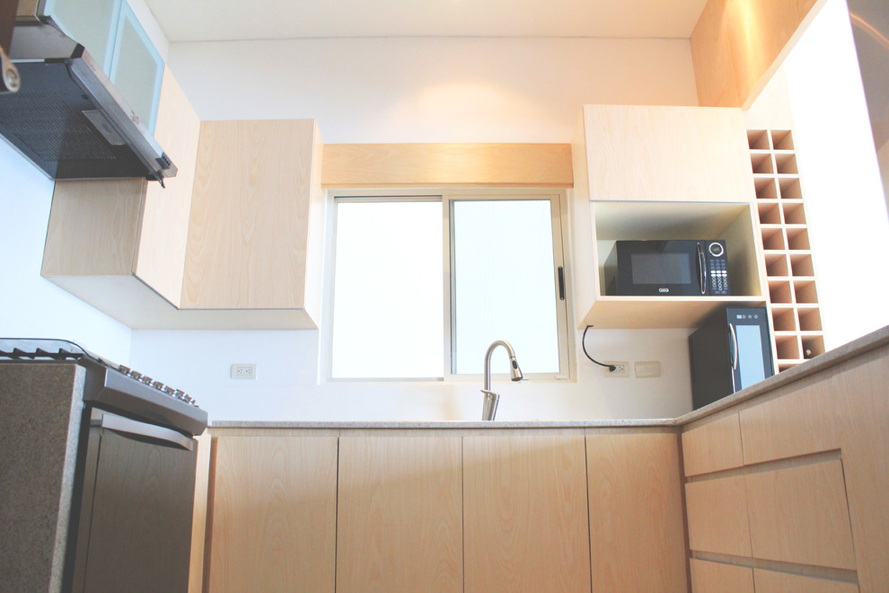Mid-sized minimalist u-shaped porcelain tile eat-in kitchen photo with a double-bowl sink, flat-panel cabinets, light wood cabinets, granite countertops and stainless steel appliances