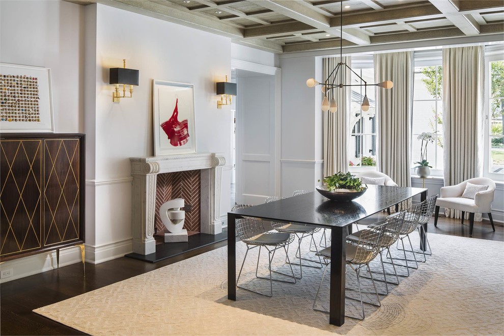 This is an example of a mid-sized transitional dining room in New York with a brick fireplace surround, white walls, dark hardwood floors, a standard fireplace and brown floor.