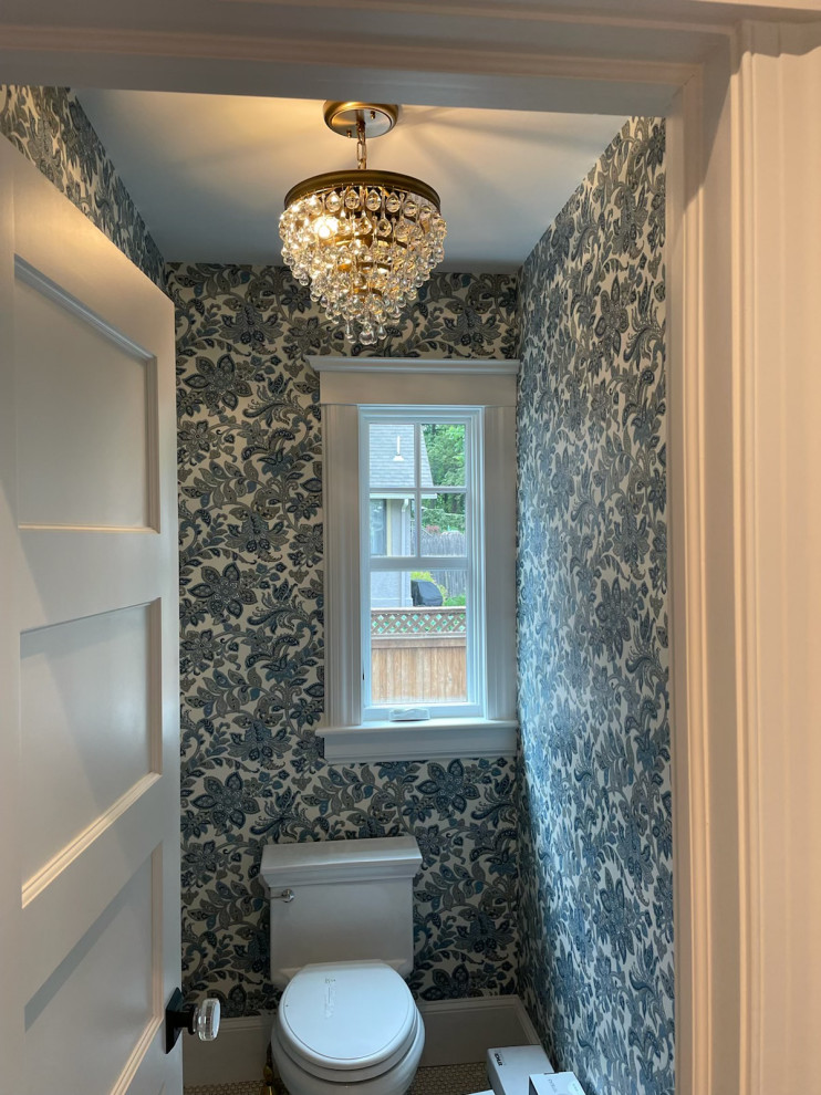 Inspiration for a classic cloakroom in New York with a two-piece toilet, pebble tile flooring, a wall-mounted sink, grey floors and wallpapered walls.