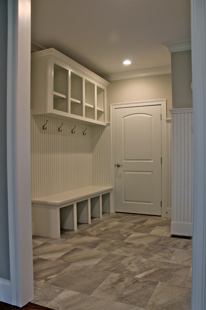 Entryway - transitional medium tone wood floor entryway idea in Boston with gray walls