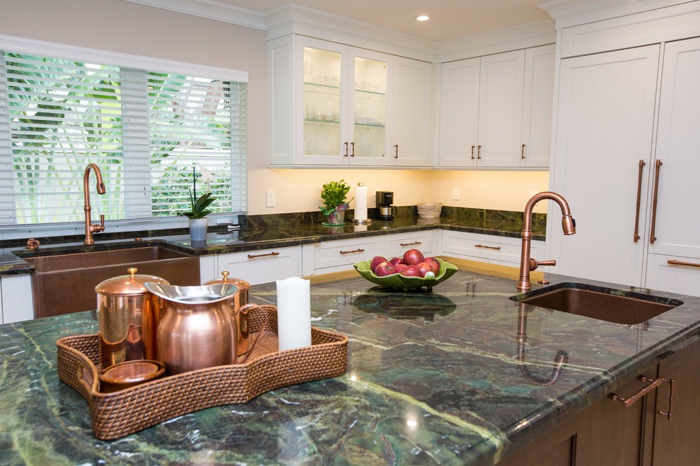 Example of a large transitional u-shaped light wood floor open concept kitchen design in Miami with a farmhouse sink, shaker cabinets, stainless steel appliances, an island, white cabinets, granite countertops, metallic backsplash and mosaic tile backsplash