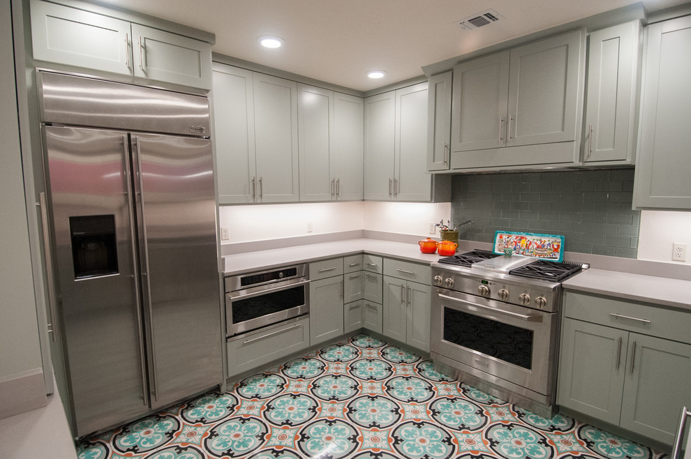 Inspiration for a mid-sized mediterranean separate kitchen in Austin with a single-bowl sink, shaker cabinets, quartz benchtops, cement tiles, green cabinets, beige splashback, stainless steel appliances and no island.