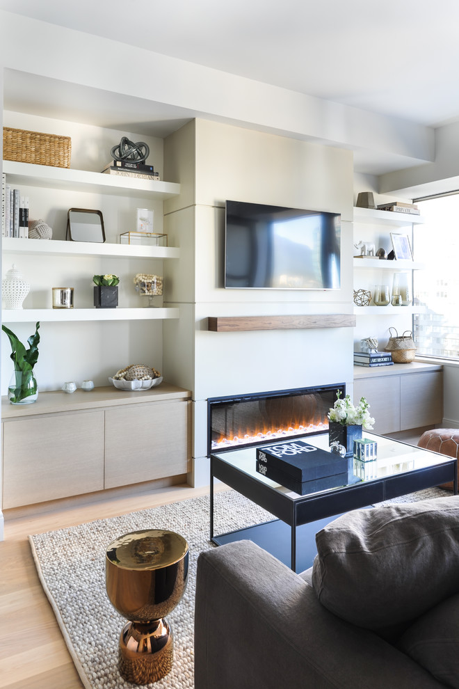 Inspiration for a mid-sized contemporary open concept family room in Vancouver with white walls, light hardwood floors, a ribbon fireplace, a wall-mounted tv, beige floor and a plaster fireplace surround.