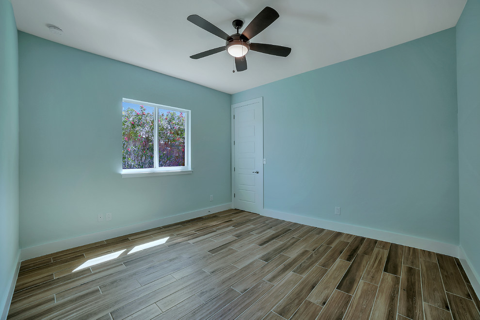 Inspiration for a mid-sized transitional guest porcelain tile bedroom remodel