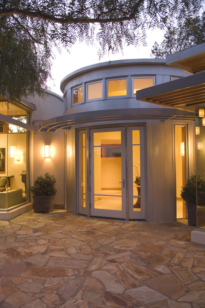 This is an example of a contemporary entryway in Los Angeles with a single front door and a glass front door.