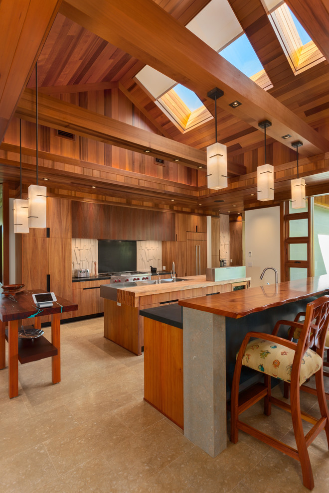 Photo of an expansive tropical galley separate kitchen in Hawaii with a double-bowl sink, flat-panel cabinets, medium wood cabinets, wood benchtops, stainless steel appliances and multiple islands.