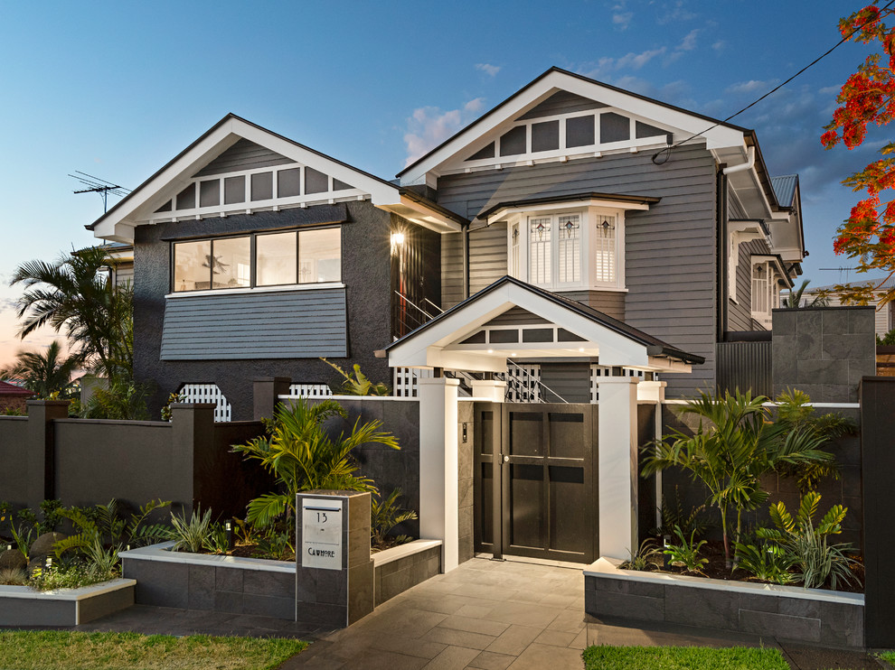 Design ideas for a large transitional two-storey black house exterior in Brisbane with a gable roof and a metal roof.