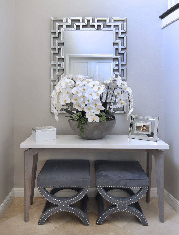 Inspiration for a mid-sized transitional ceramic tile and beige floor hallway remodel in Orange County with gray walls