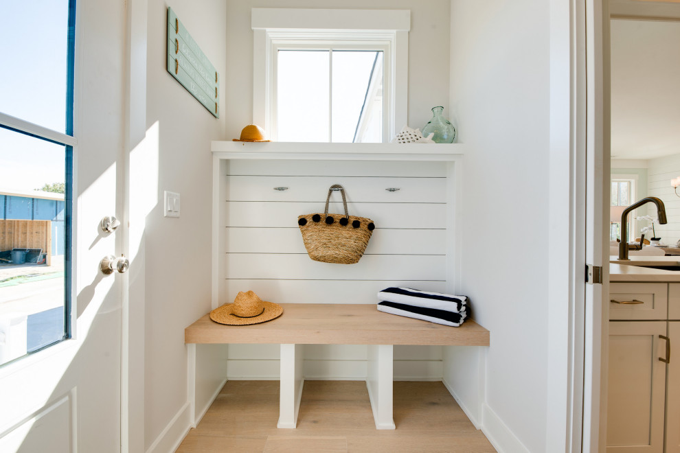 Mid-sized beach style mudroom in Other with grey walls, light hardwood floors, a single front door, a black front door, grey floor and planked wall panelling.