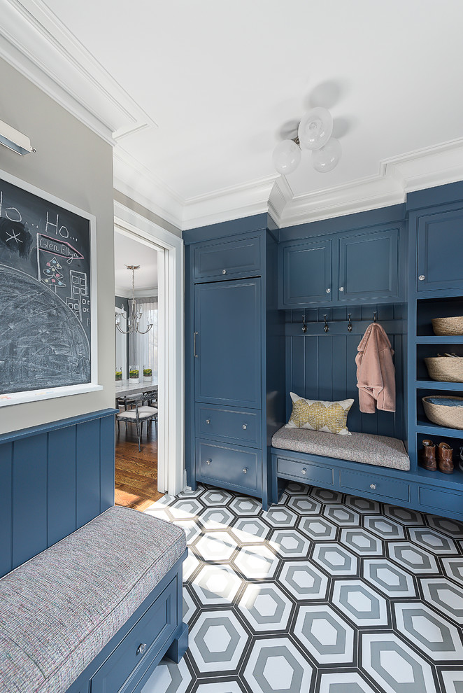 Photo of a mid-sized traditional mudroom in Chicago with grey walls, medium hardwood floors and black floor.