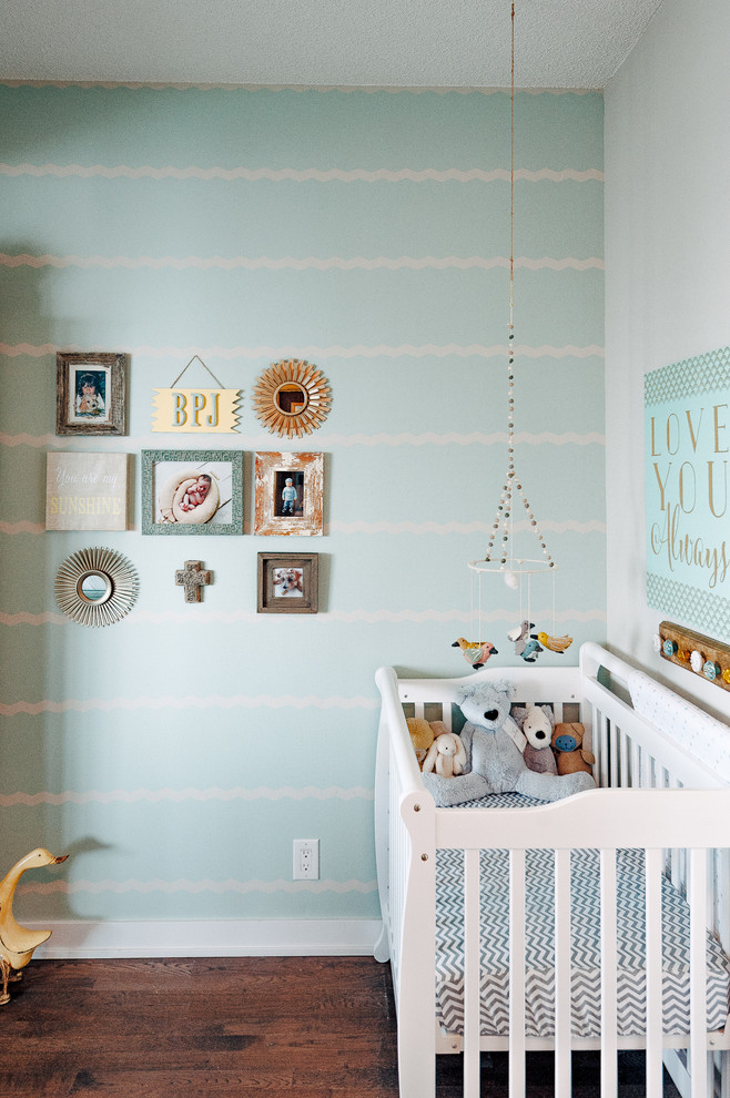 Design ideas for a transitional gender-neutral nursery in Toronto with green walls, dark hardwood floors and brown floor.