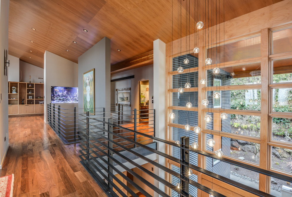 Inspiration for a mid-sized modern medium tone wood floor hallway remodel in Seattle with multicolored walls