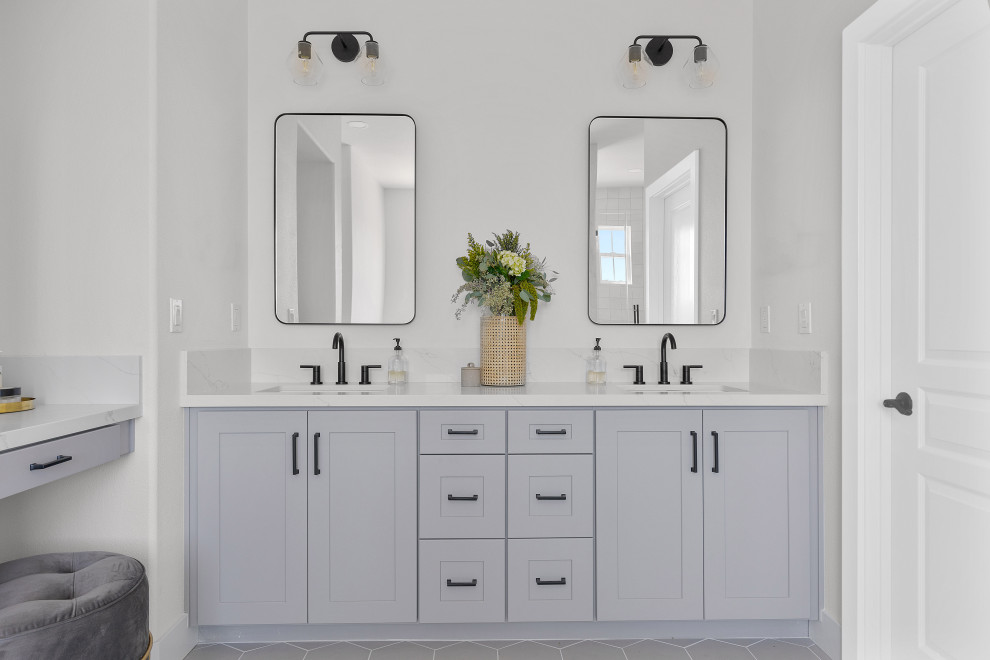 Large minimalist master white tile and marble tile gray floor and double-sink freestanding bathtub photo in Orange County with recessed-panel cabinets, gray cabinets, white walls, an undermount sink, marble countertops, white countertops and a built-in vanity