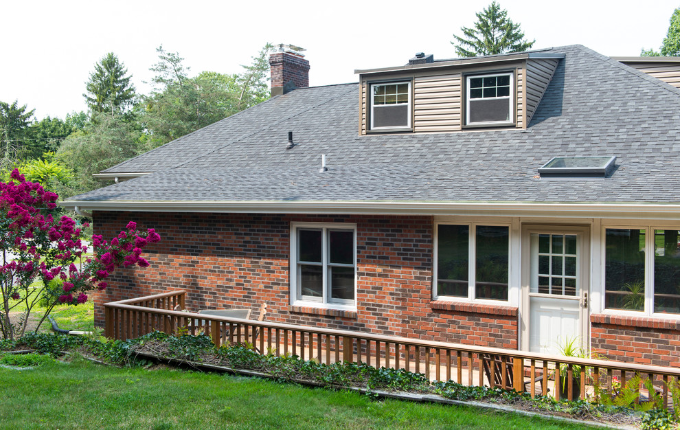 Example of a small transitional backyard deck design with no cover