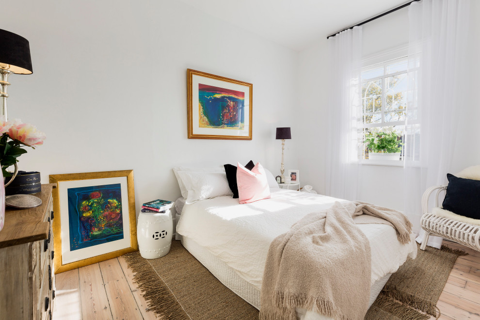 Photo of a contemporary bedroom in Sydney with white walls, light hardwood floors and beige floor.