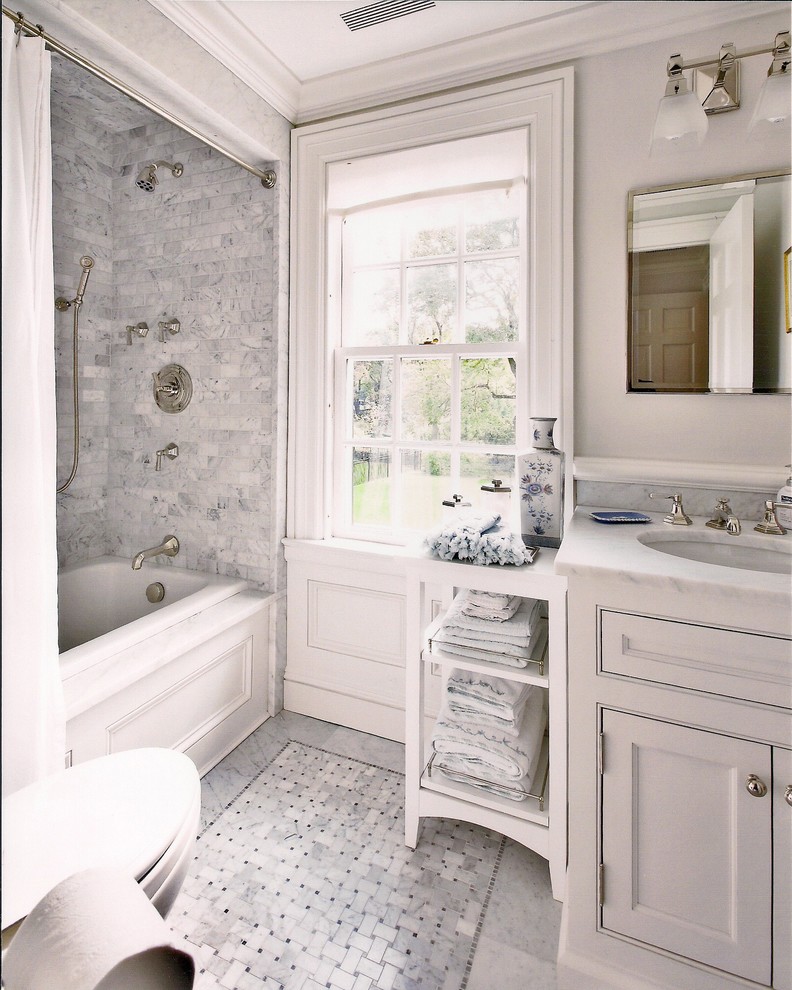 Design ideas for a small traditional bathroom in New York with shaker cabinets, white cabinets, an alcove tub, an alcove shower, white tile, white walls, mosaic tile floors, an undermount sink and marble benchtops.