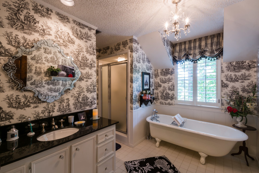 Photo of a large traditional kids bathroom in Houston with an undermount sink, flat-panel cabinets, white cabinets, granite benchtops, a claw-foot tub, an alcove shower, white tile, ceramic tile, multi-coloured walls and ceramic floors.