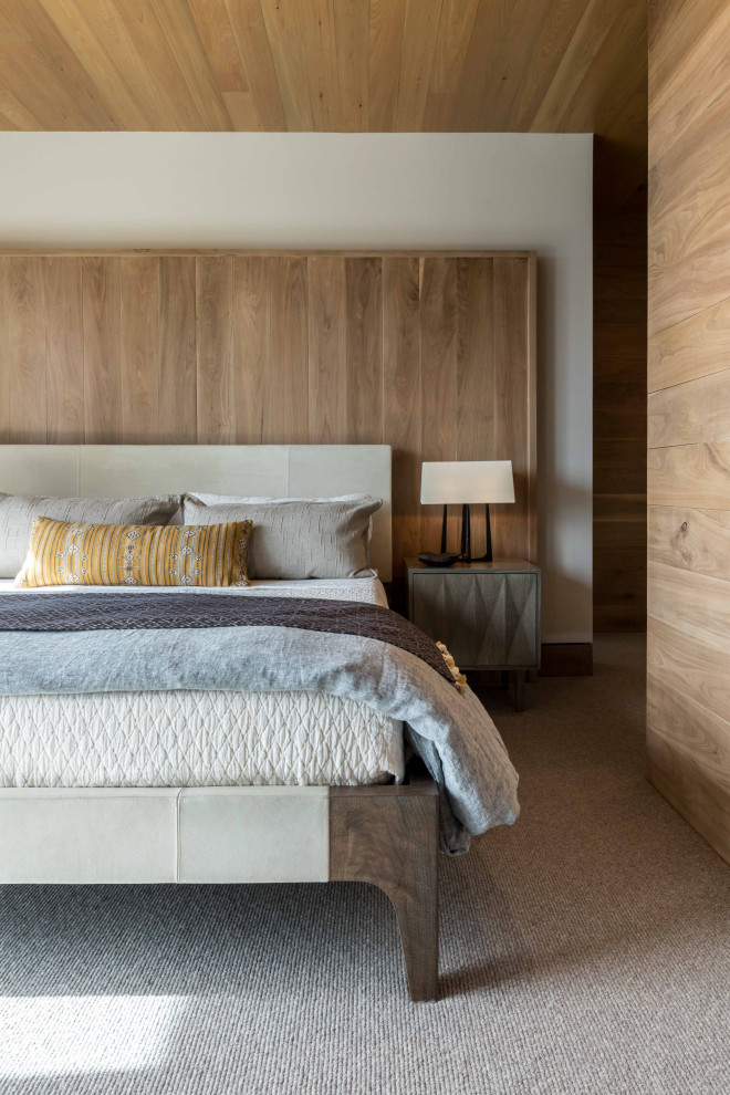 This is an example of a mid-sized country guest bedroom in Other with white walls, carpet, wood and wood walls.