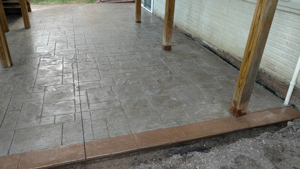 This is an example of a large traditional backyard patio in Other with a fire feature, stamped concrete and no cover.
