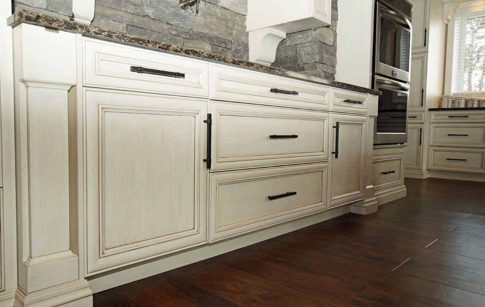 Inspiration for a large rustic galley kitchen remodel with an undermount sink, recessed-panel cabinets, white cabinets, quartzite countertops, stainless steel appliances and brown countertops