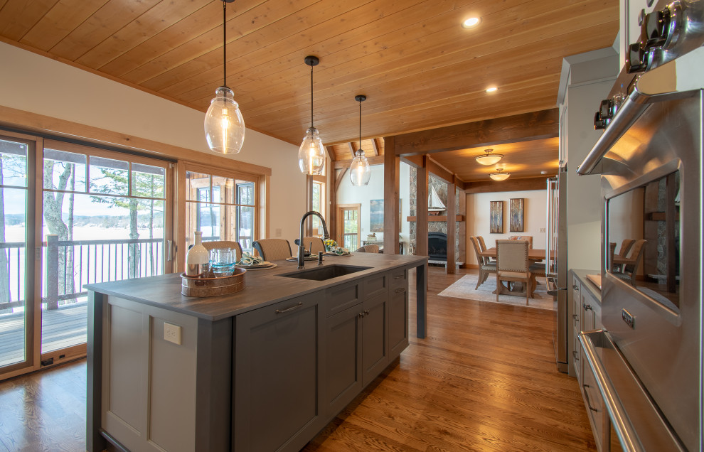 Mountain style wood ceiling eat-in kitchen photo with gray cabinets, laminate countertops and two islands