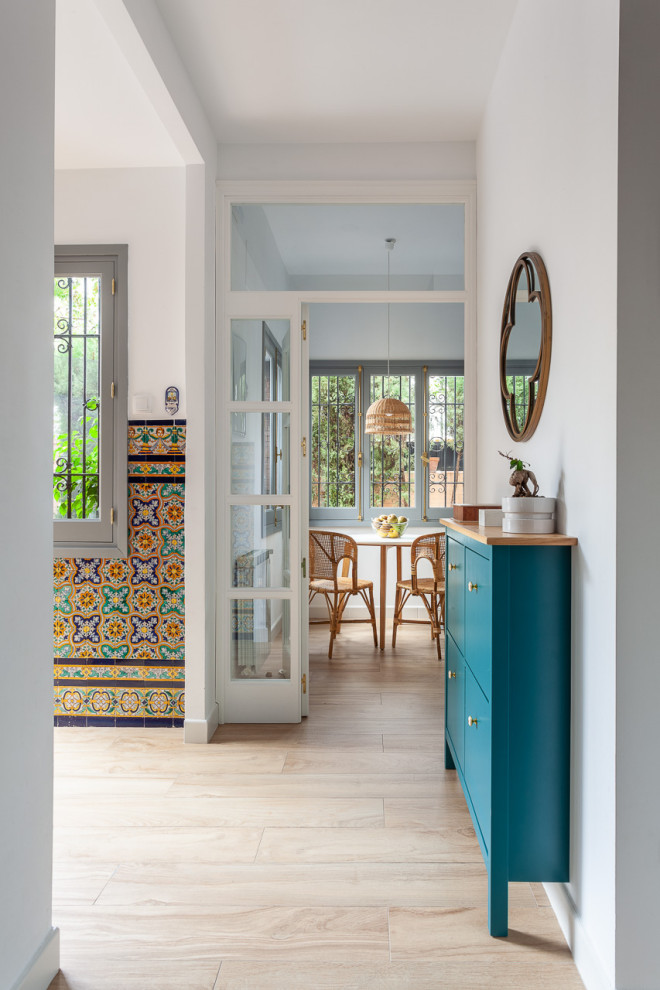 Inspiration for a mid-sized mediterranean hallway in Seville with ceramic floors, beige floor and grey walls.