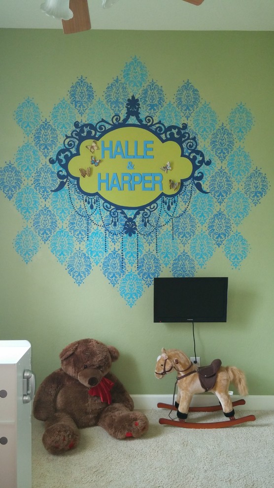 Design ideas for a mid-sized traditional kids' playroom for kids 4-10 years old and girls in Houston with green walls and carpet.