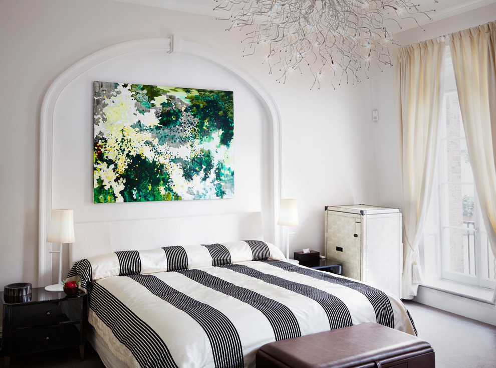 This is an example of a mid-sized traditional guest bedroom in London with white walls.