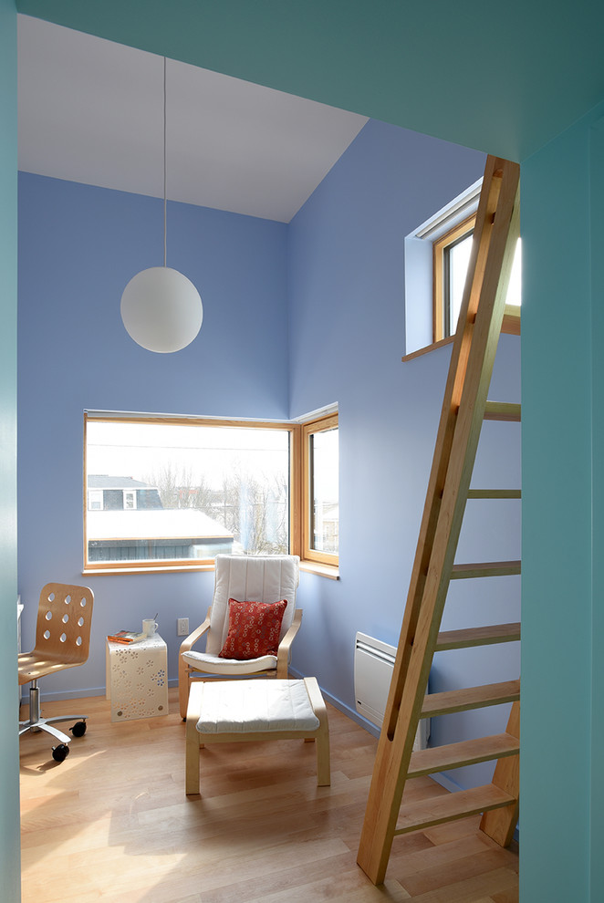 Inspiration for a contemporary loft-style bedroom in Portland Maine with blue walls, light hardwood floors and no fireplace.
