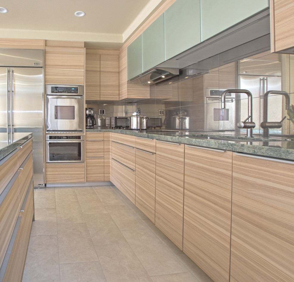 Photo of a mid-sized contemporary l-shaped eat-in kitchen in Hawaii with a single-bowl sink, flat-panel cabinets, light wood cabinets, granite benchtops, porcelain splashback, panelled appliances, porcelain floors, beige floor and with island.