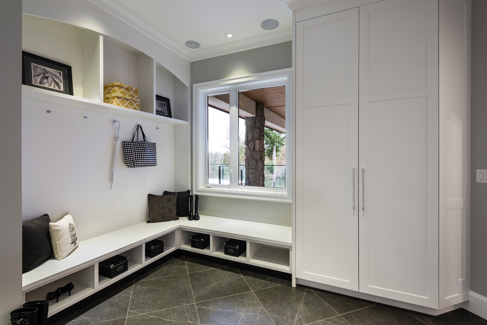 Mudroom - huge rustic porcelain tile and gray floor mudroom idea in Vancouver with gray walls and a dark wood front door