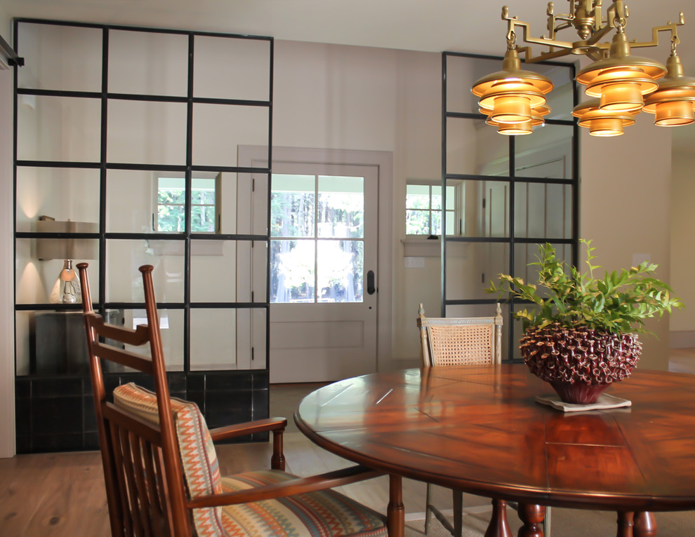 This is an example of a contemporary dining room in Portland Maine with white walls and dark hardwood floors.
