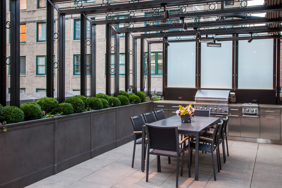 Elegant patio kitchen photo in Chicago with an awning