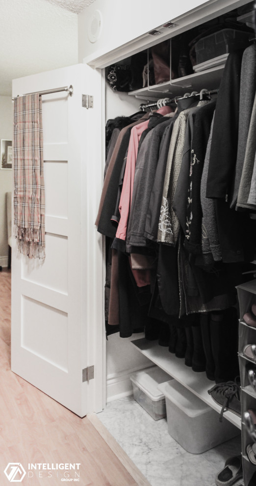 Small transitional gender-neutral laminate floor built-in closet photo in Toronto with shaker cabinets
