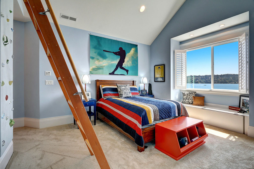 This is an example of a traditional kids' room for kids 4-10 years old and boys in Seattle with blue walls, carpet and beige floor.
