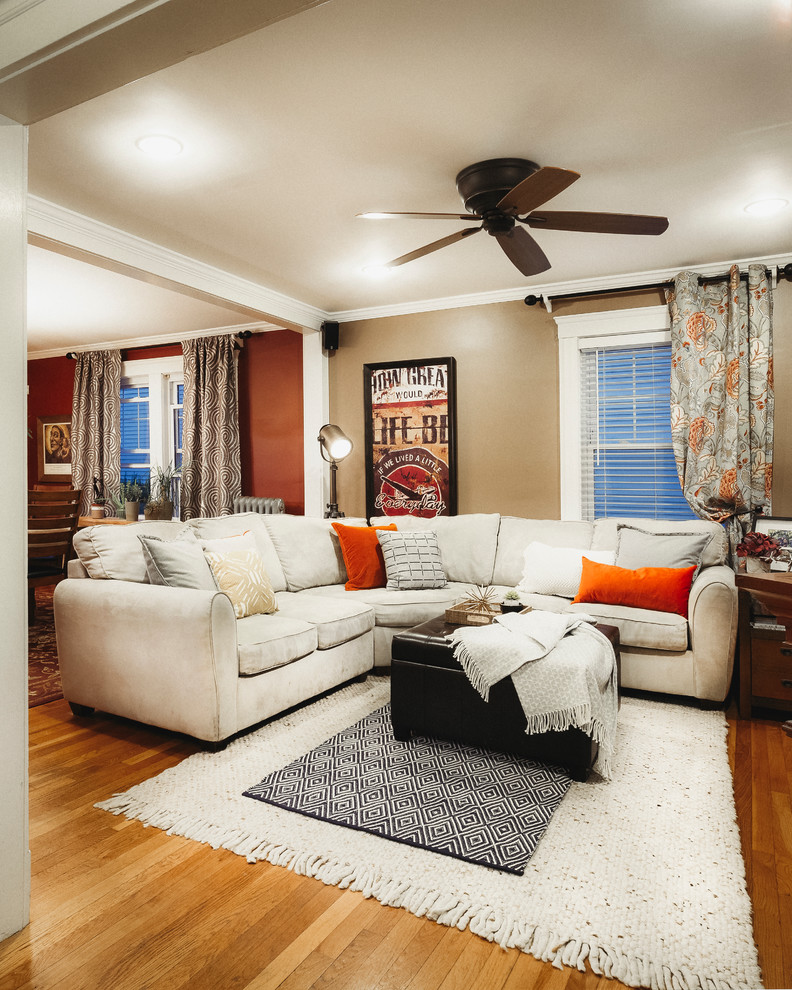 Photo of a mid-sized traditional open concept family room in Boston with brown walls and light hardwood floors.